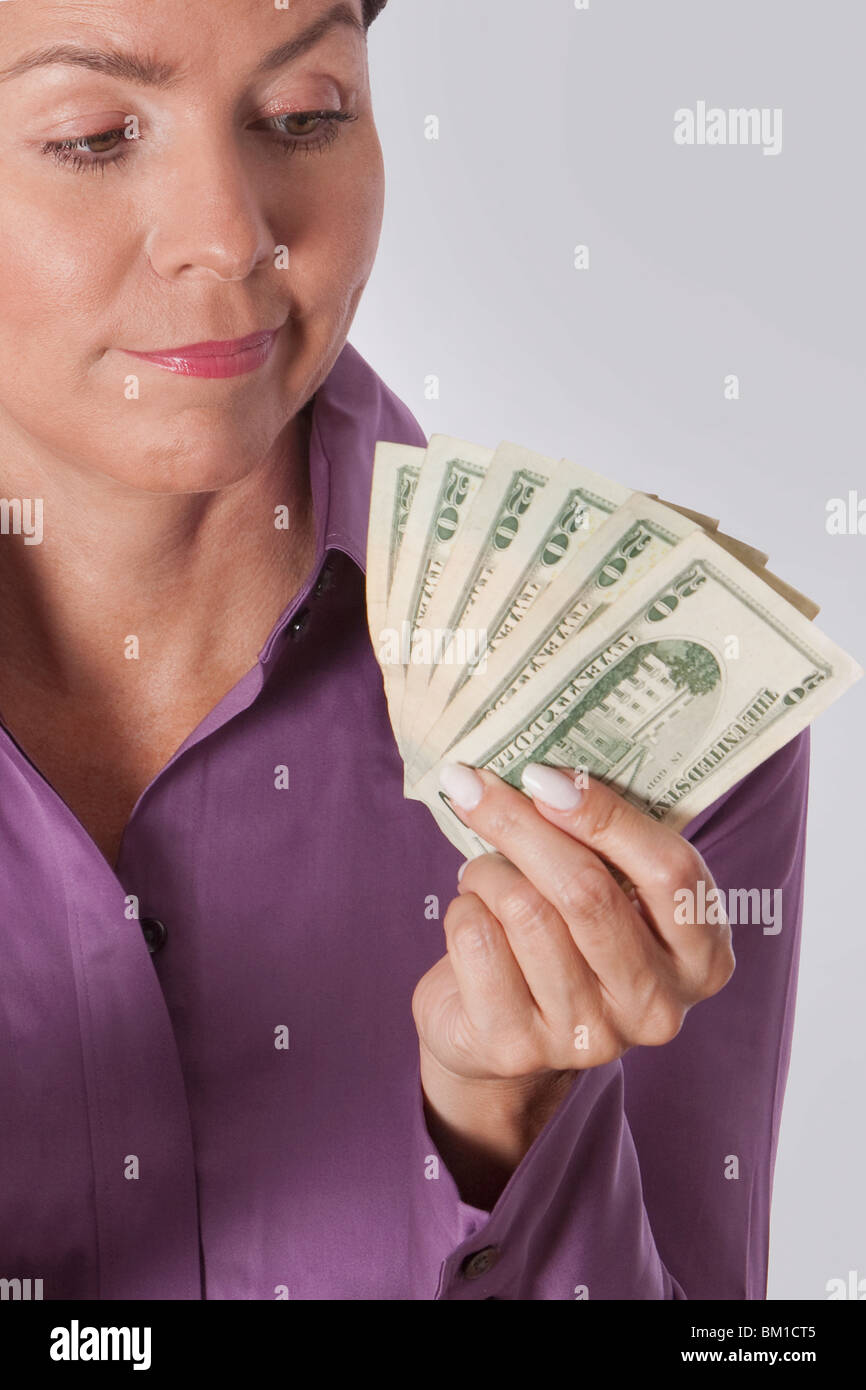 Woman holding currency notes Stock Photo