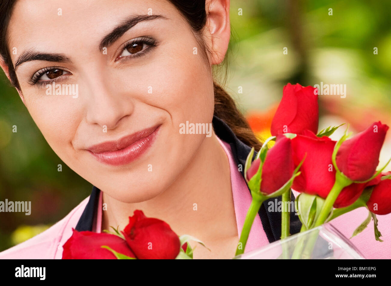 Portrait of a woman smiling in a greenhouse Stock Photo - Alamy