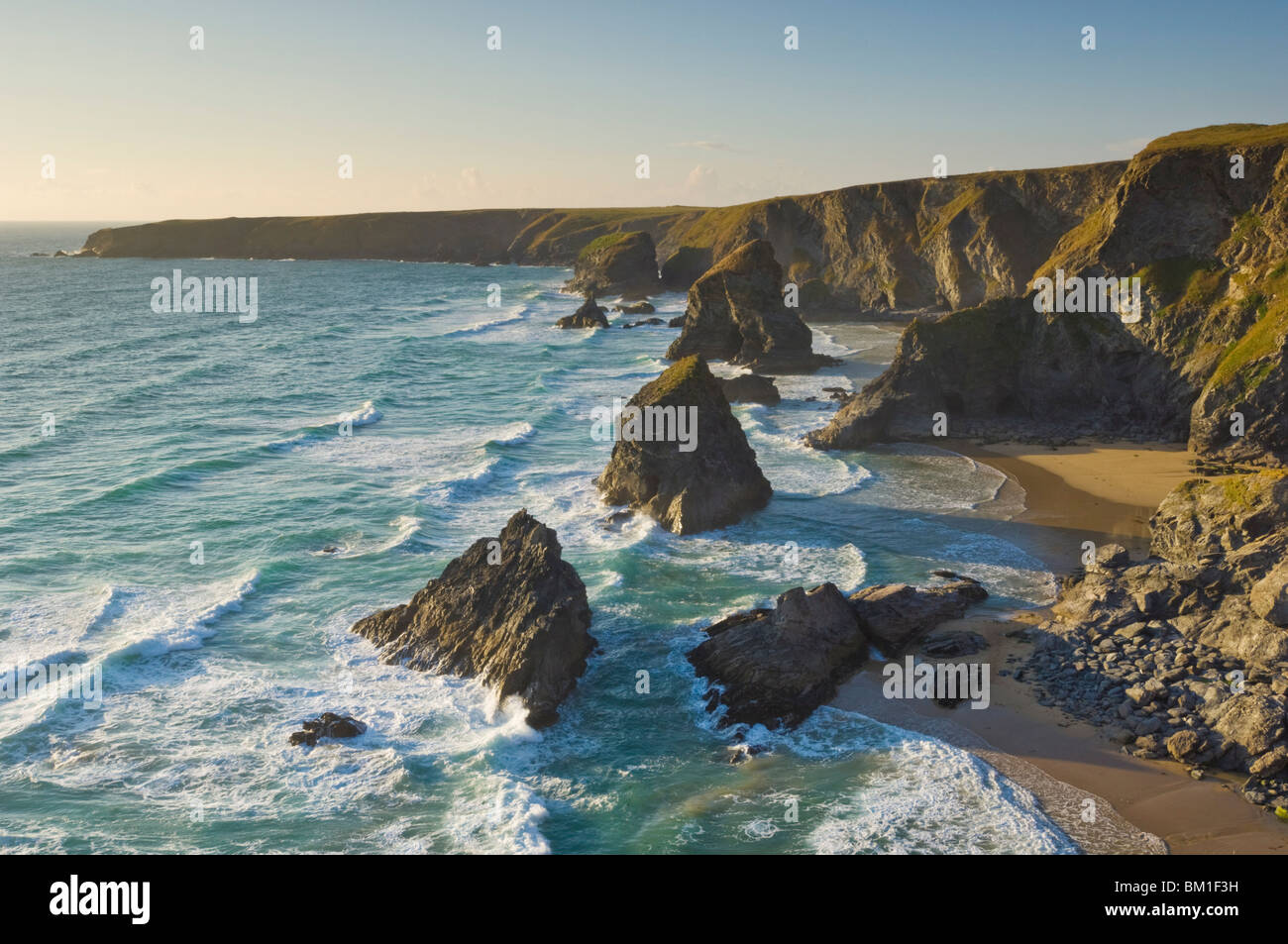 Evening light on the rock stacks, beach and rugged coastline at Bedruthan Steps, North Cornwall, England, United Kingdom, Europe Stock Photo