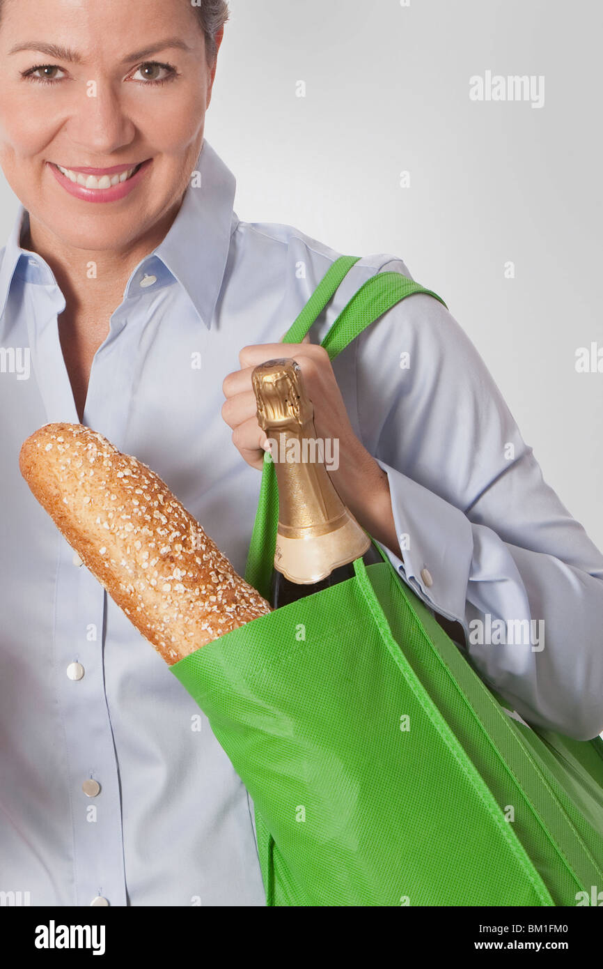 Woman carrying a bag of groceries Stock Photo Alamy