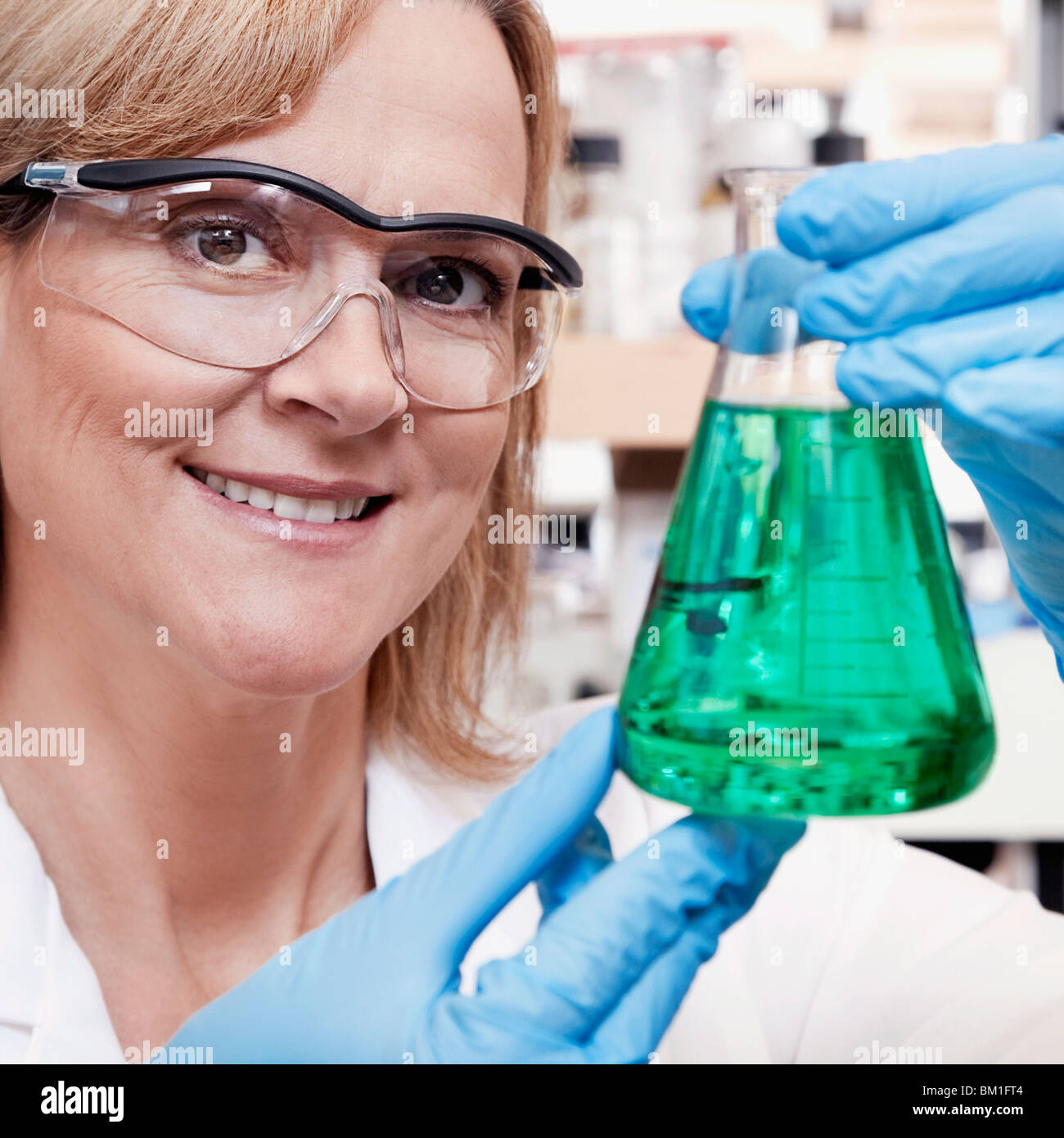 Female doctor holding a conical flask in a laboratory Stock Photo Alamy