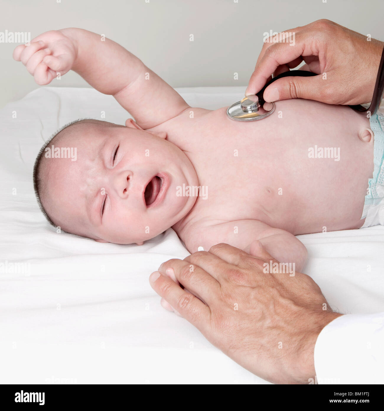 Doctor examining a newborn baby Stock Photo - Alamy