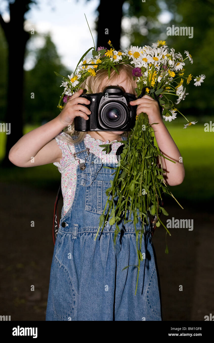 little girl with a bunch of flowers and a wreath photographs Stock ...