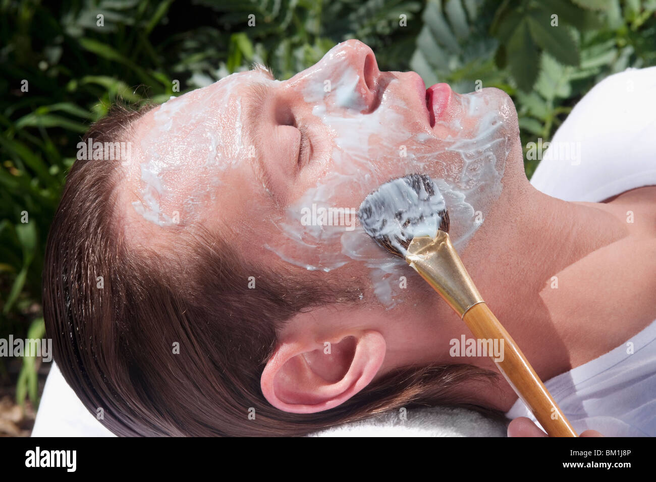 Man applying facial mask Stock Photo
