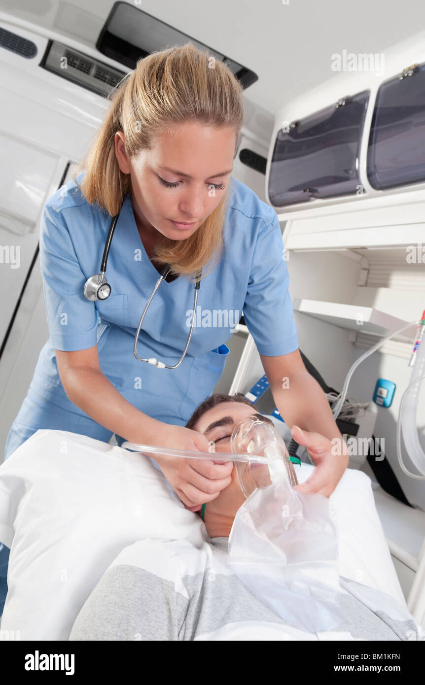 Female nurse assisting a patient in an ambulance Stock Photo Alamy