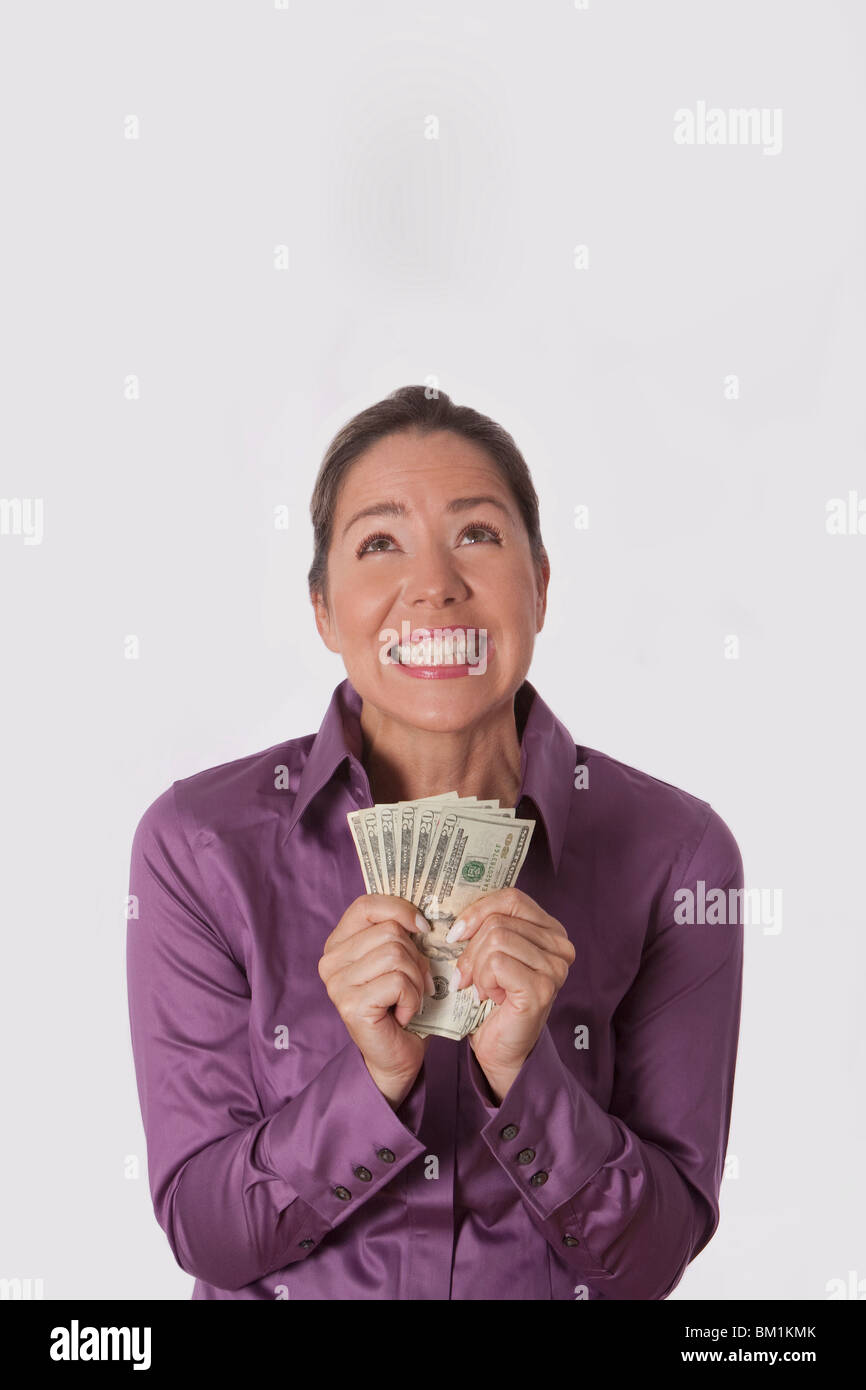 Woman holding currency notes Stock Photo