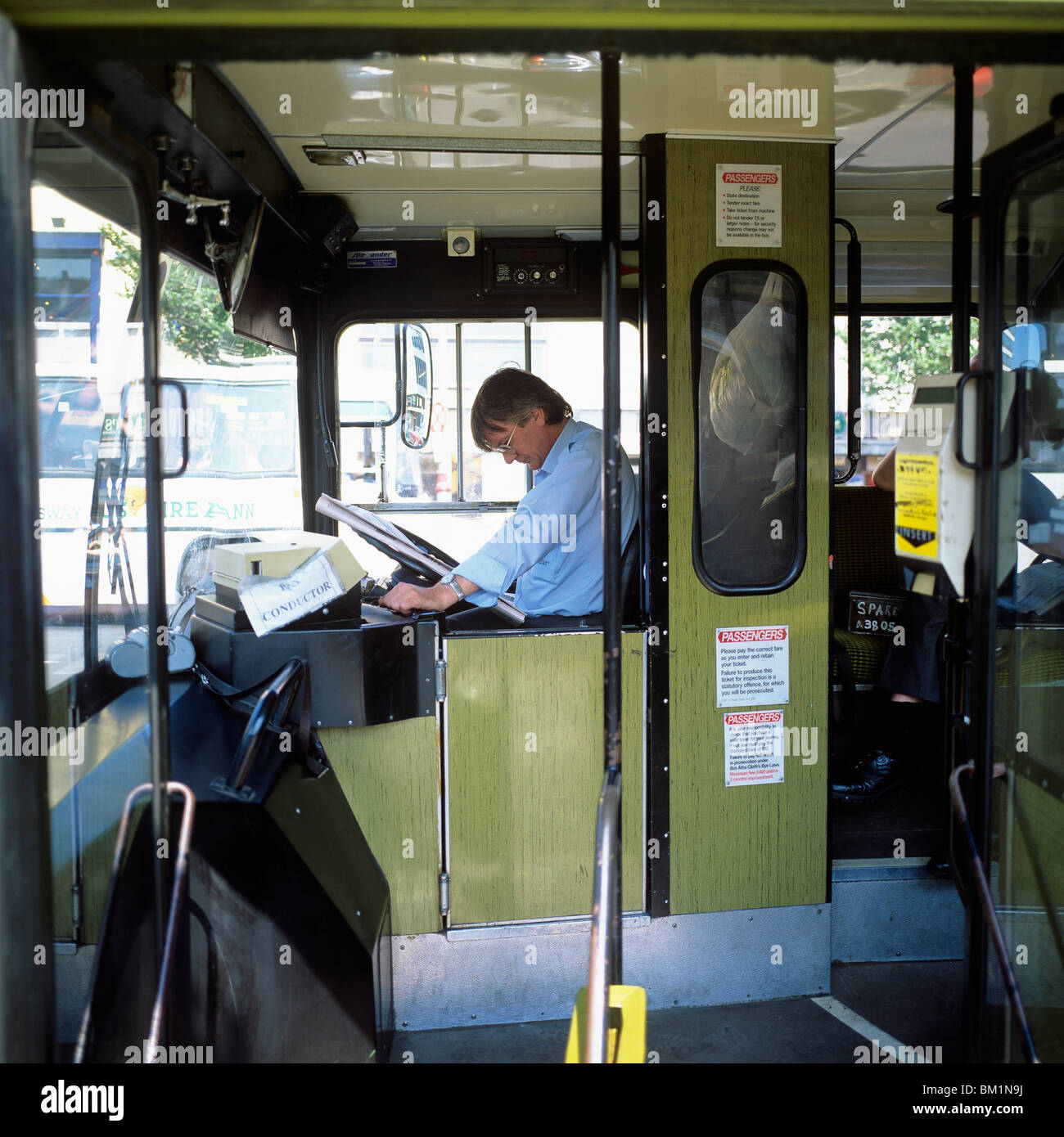 BUS DRIVER READING NEWSPAPER DUBLIN IRELAND europe Stock Photo