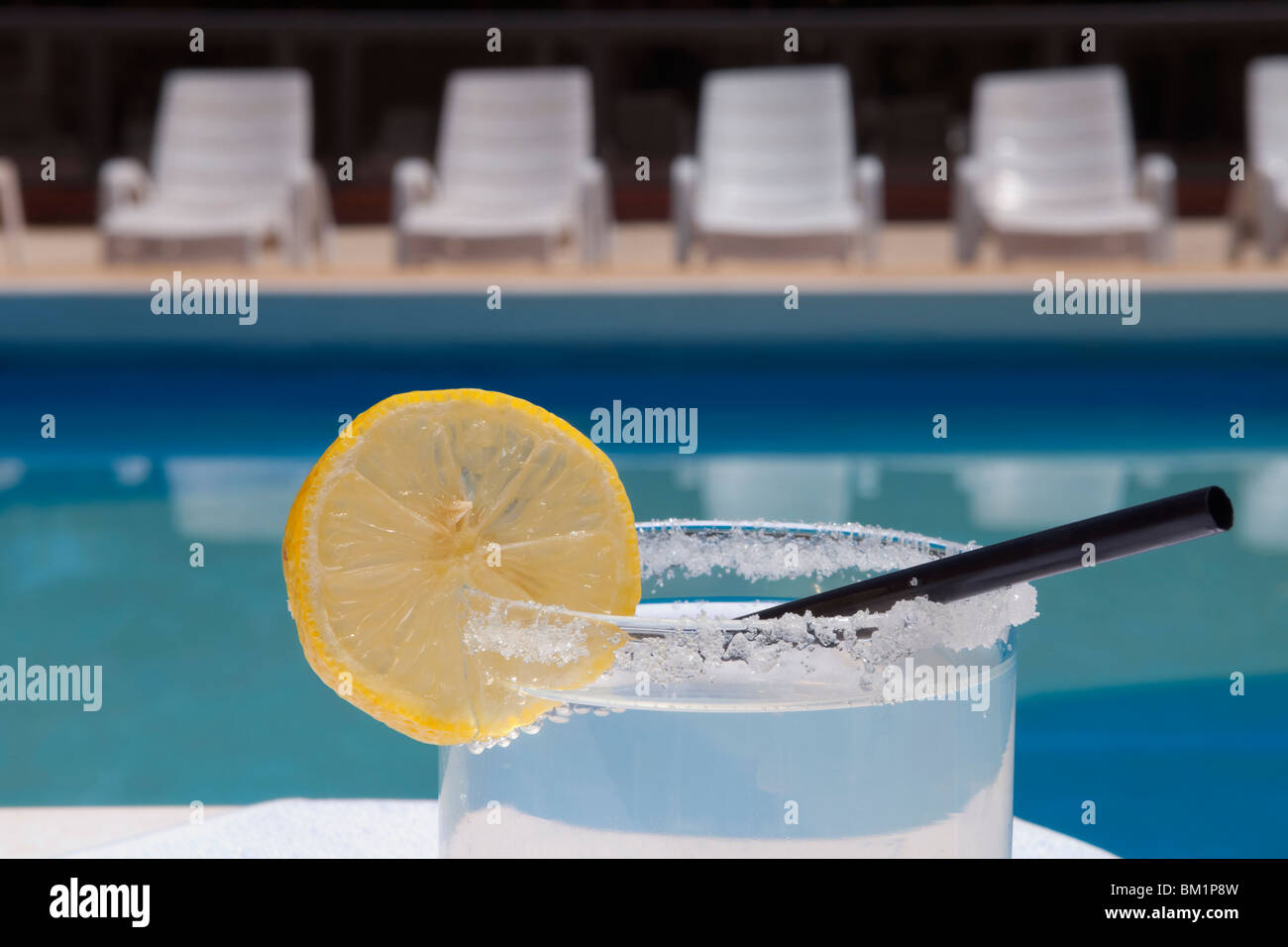 Glass of lemonade at the poolside Stock Photo
