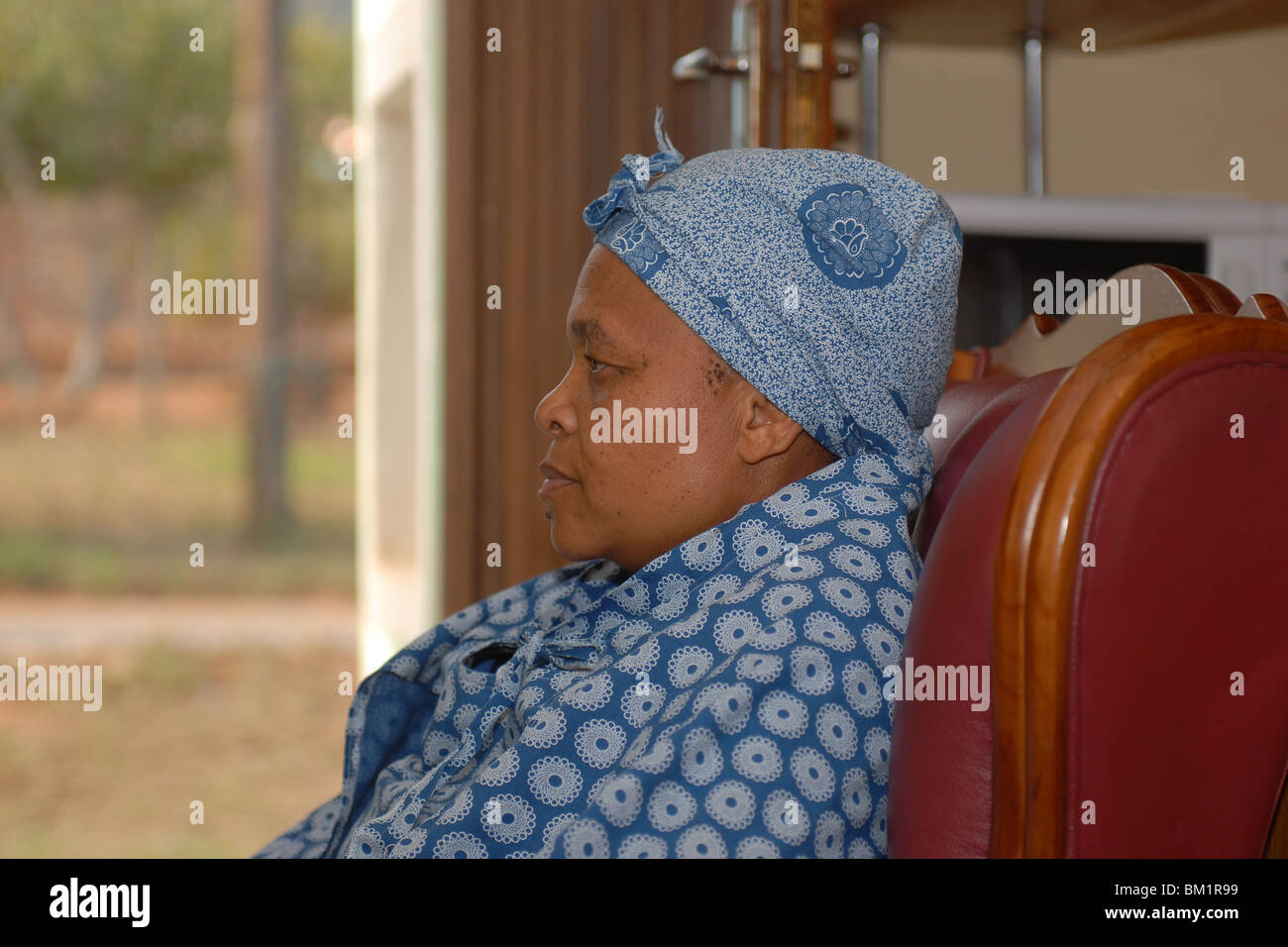 Black lady in a chair Stock Photo