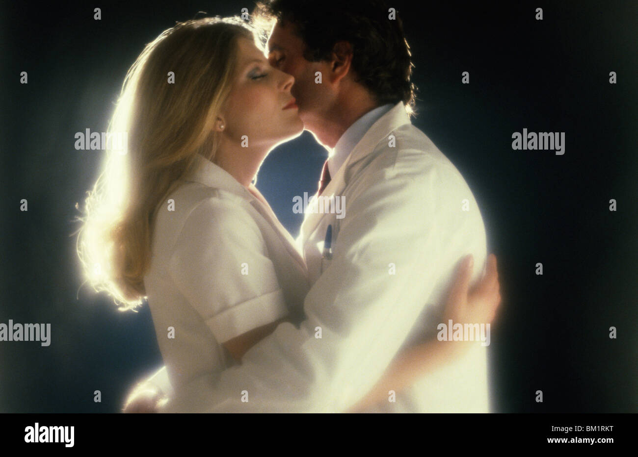 Man and woman embracing in backlit Stock Photo