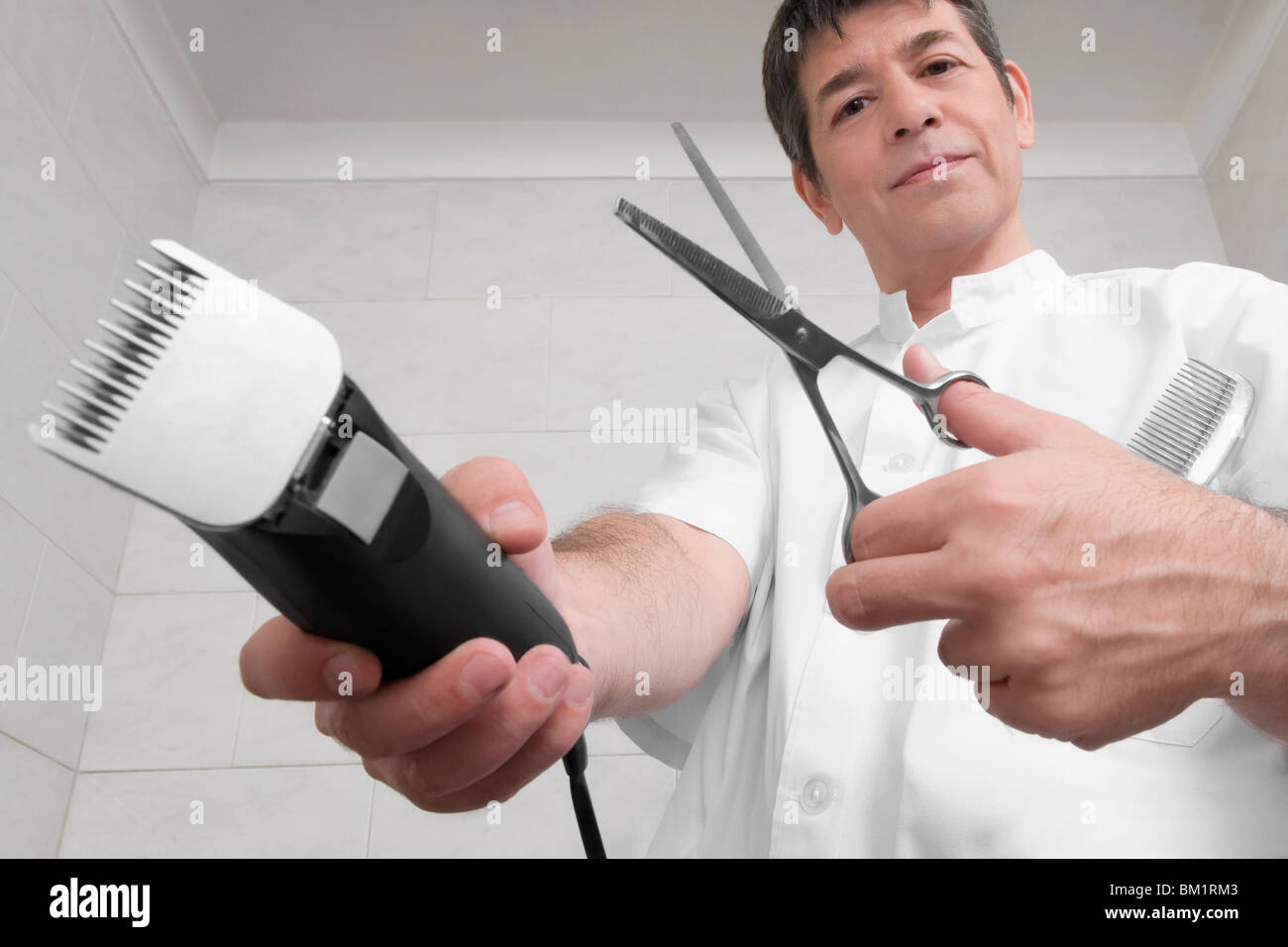 Vet holding an electric razor and scissors Stock Photo - Alamy