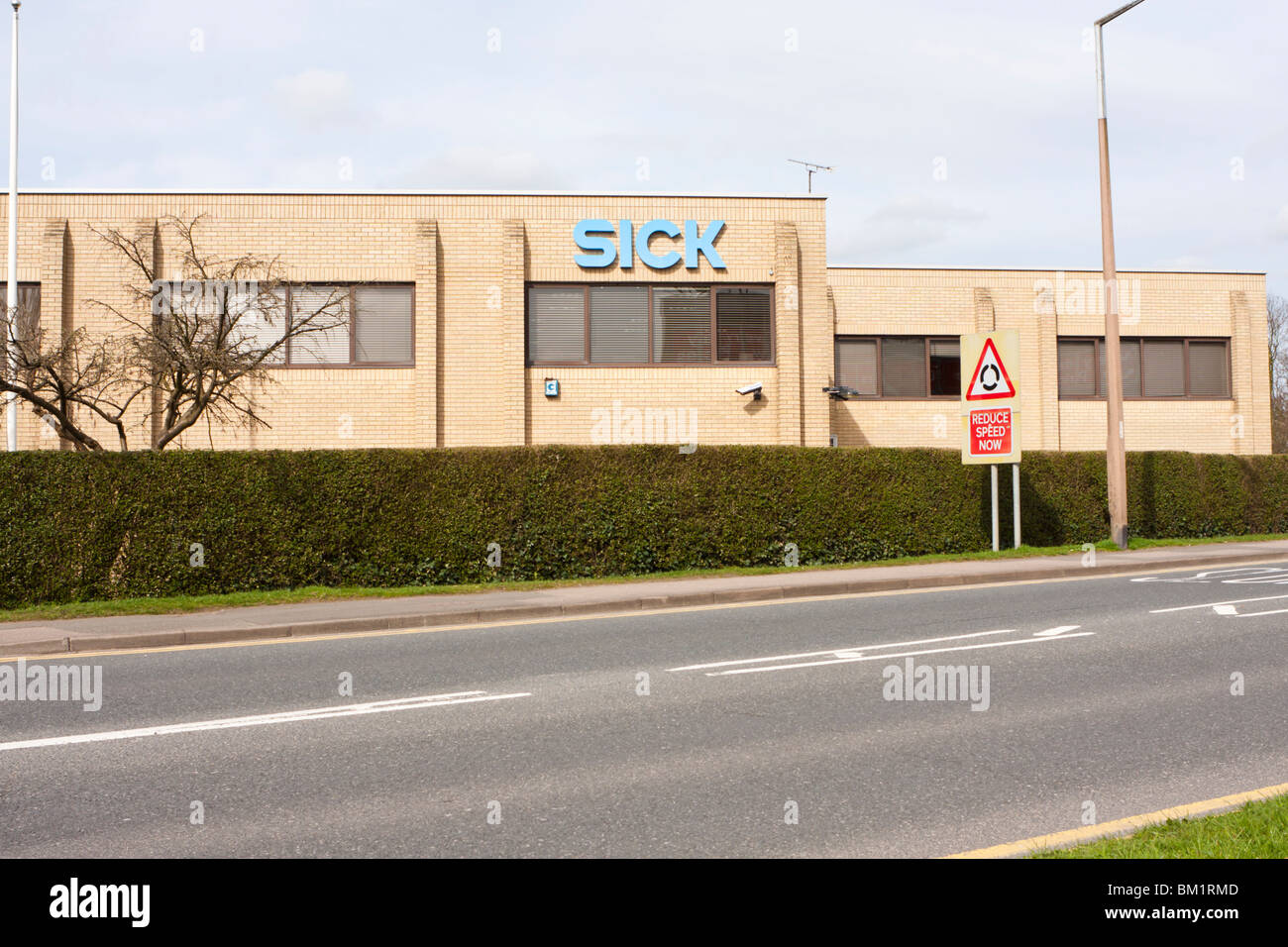 Office building with large Sick lettering on side Stock Photo - Alamy