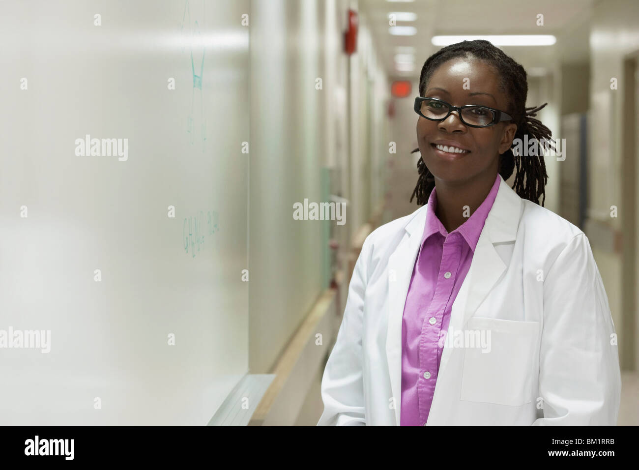 Portrait of a female doctor smiling in a hospital corridor Stock Photo