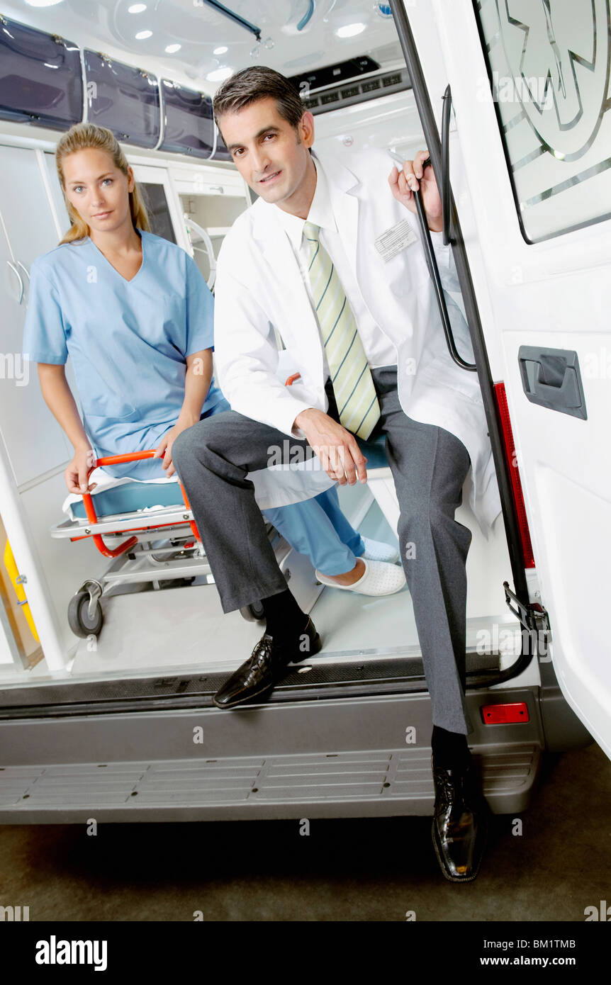 Doctor sitting with a female nurse in an ambulance Stock Photo
