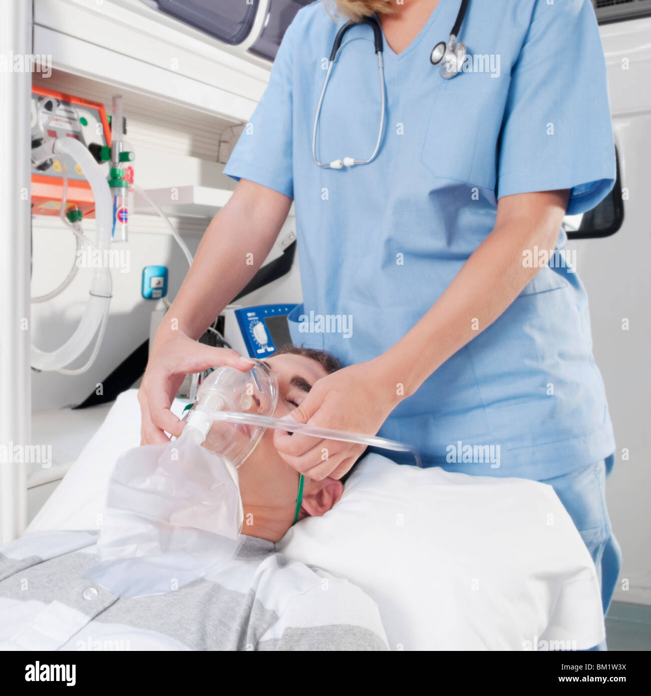 Female nurse assisting a patient in an ambulance Stock Photo