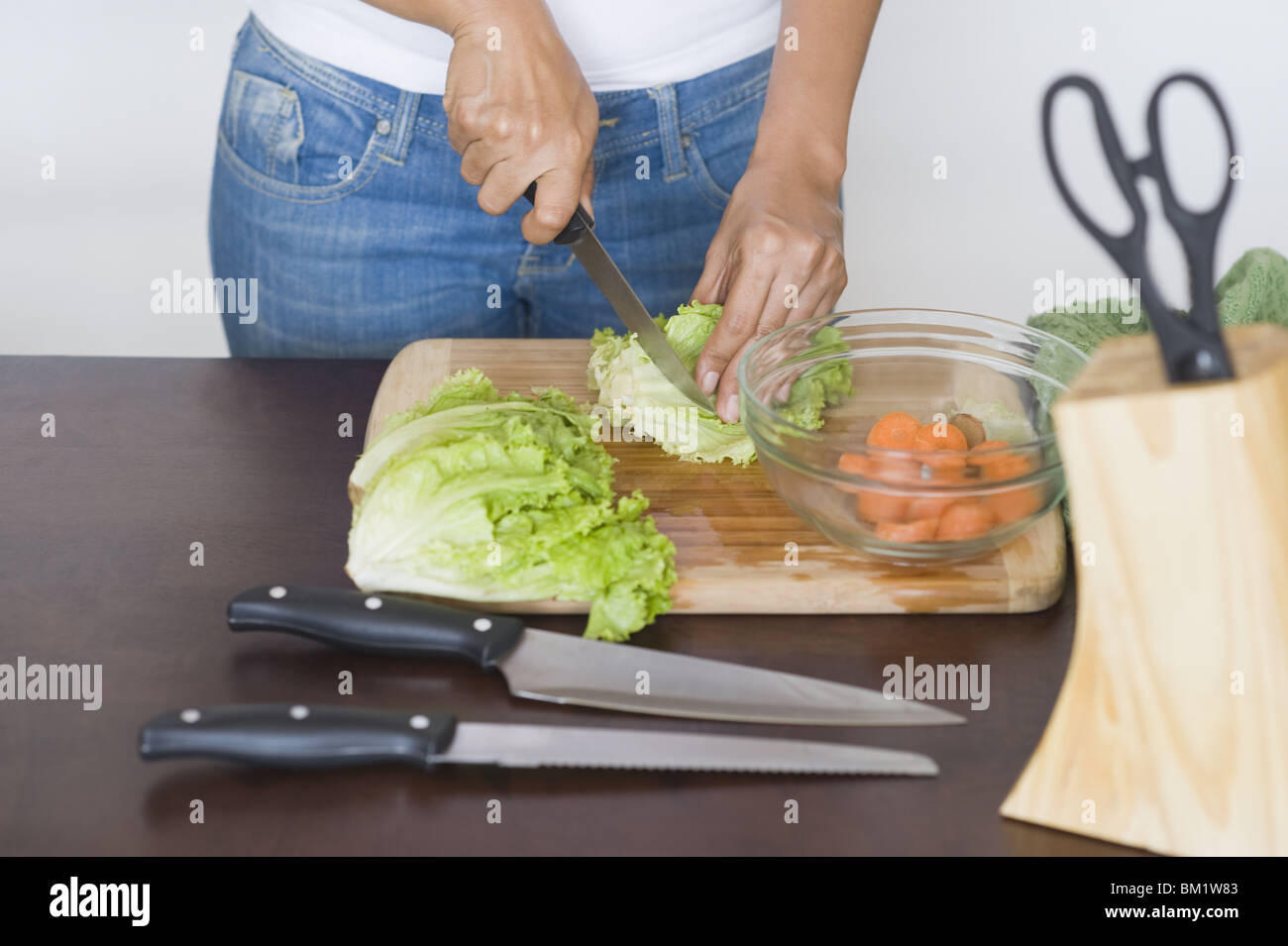 Mid section view of a woman chopping lettuce Stock Photo Alamy