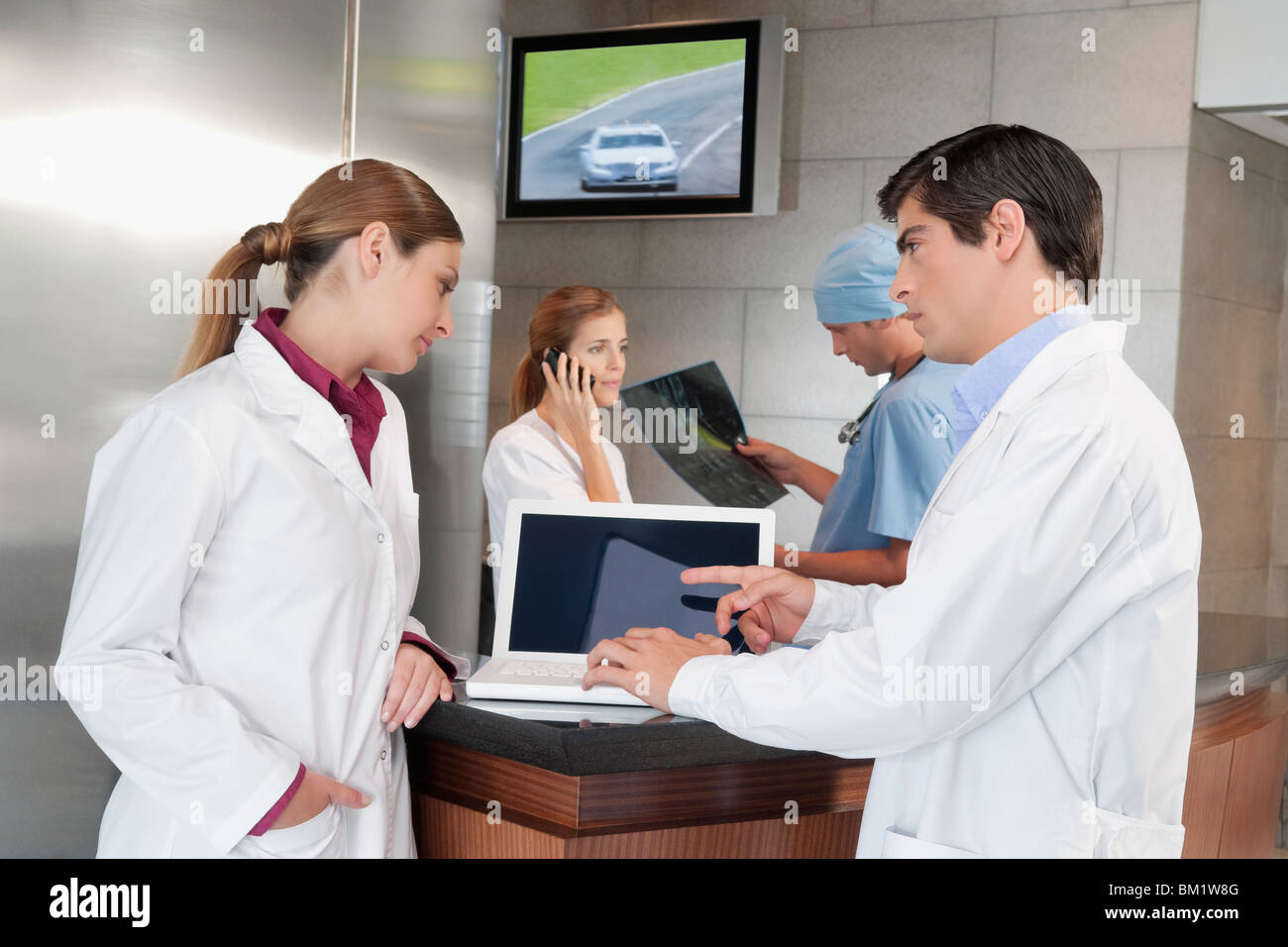 Two male doctors examining laptop hi-res stock photography and images ...