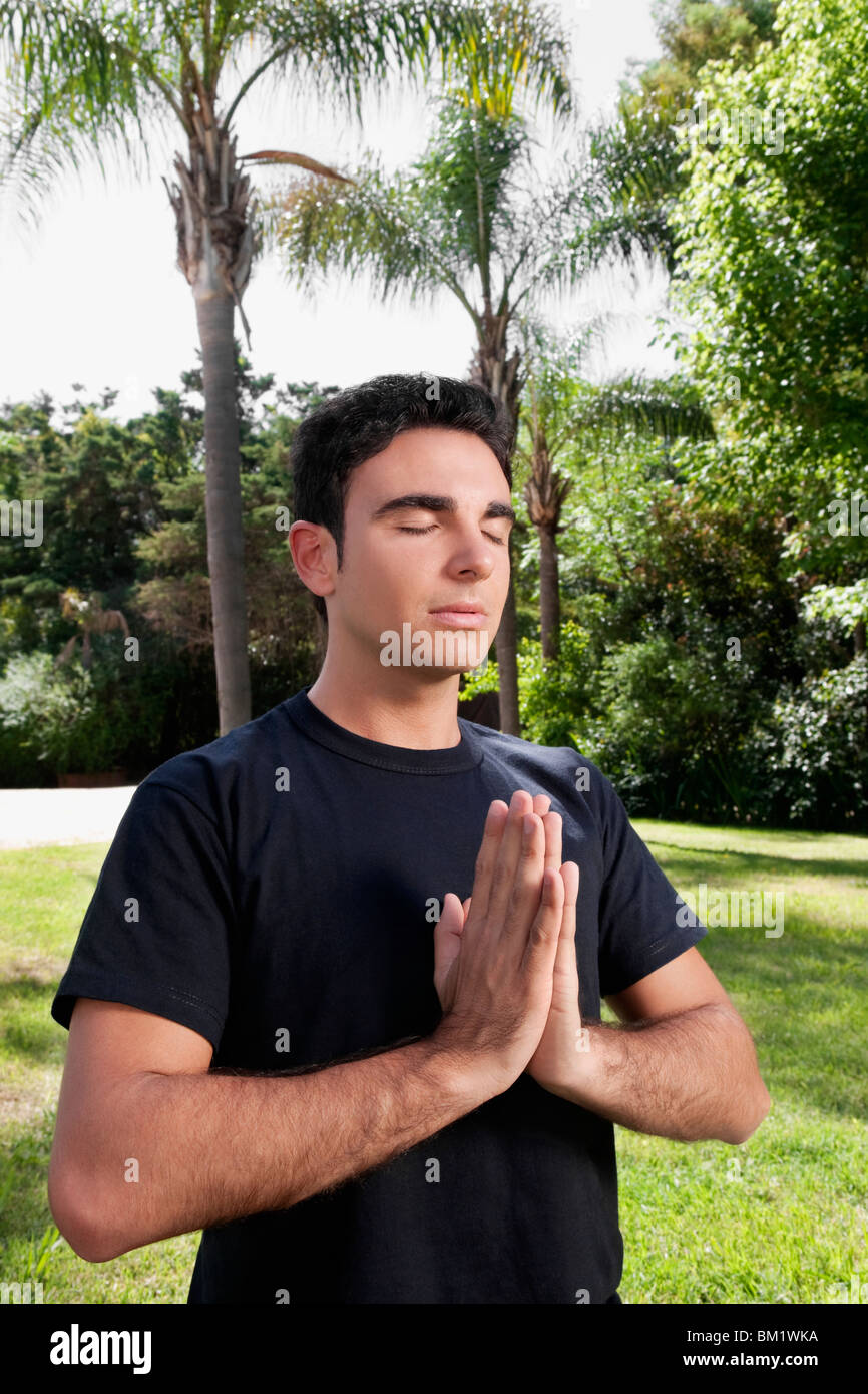 Man practicing yoga in a park Stock Photo - Alamy