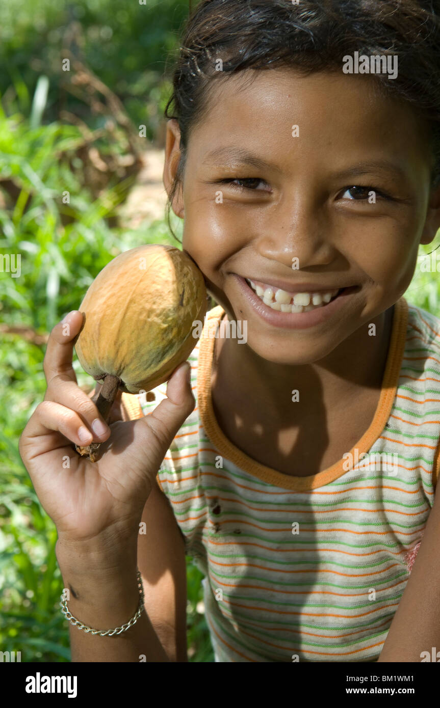 Portrait of a girl holding a Cacaurana fruit, Boa Esperanca, Amazonas, Brazil Stock Photo