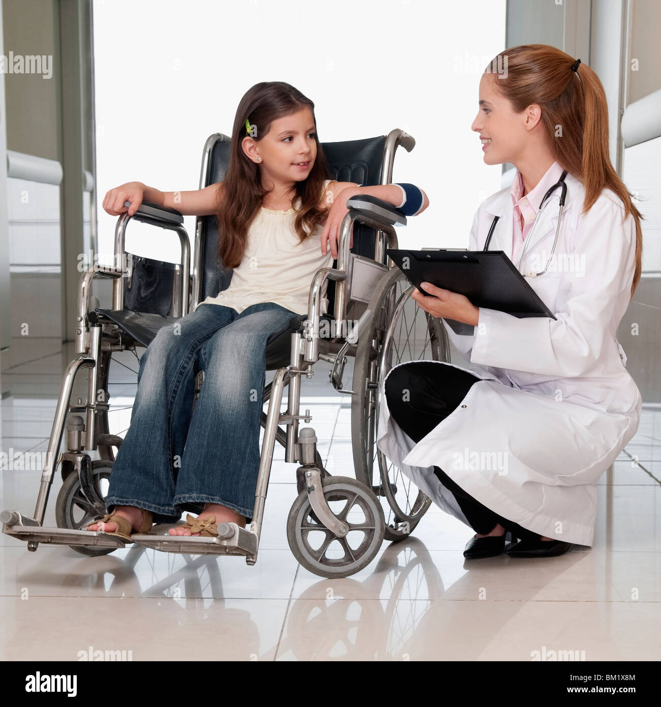 Female doctor with a patient in a wheelchair Stock Photo
