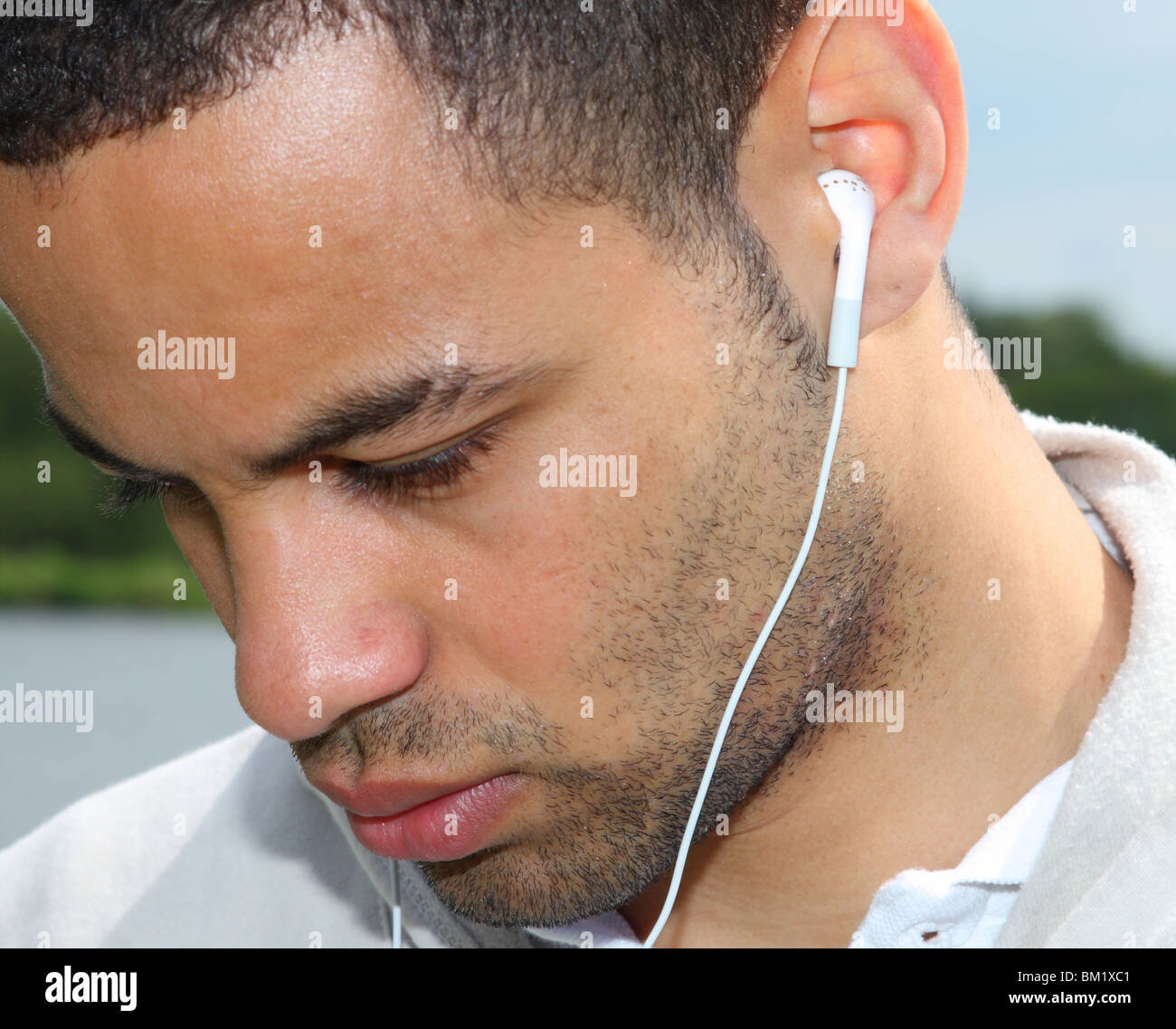 Professional footballer Ben Fairclough listening to music on an Ipod MP3 player. Stock Photo