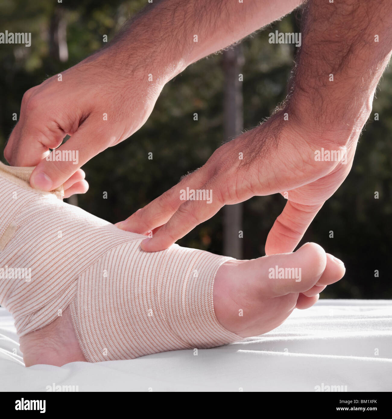 Doctor tying crepe bandage on a patient's foot Stock Photo Alamy