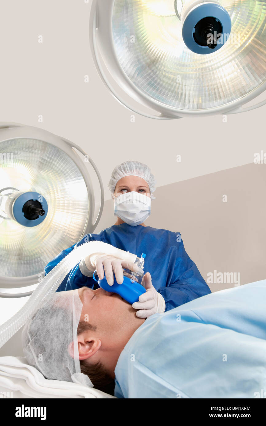 Doctor anaesthetizing a patient in an operating room Stock Photo