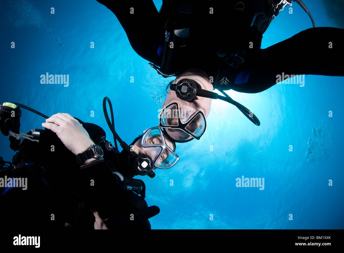 Scuba divers hovering together on a safety stop. Stock Photo