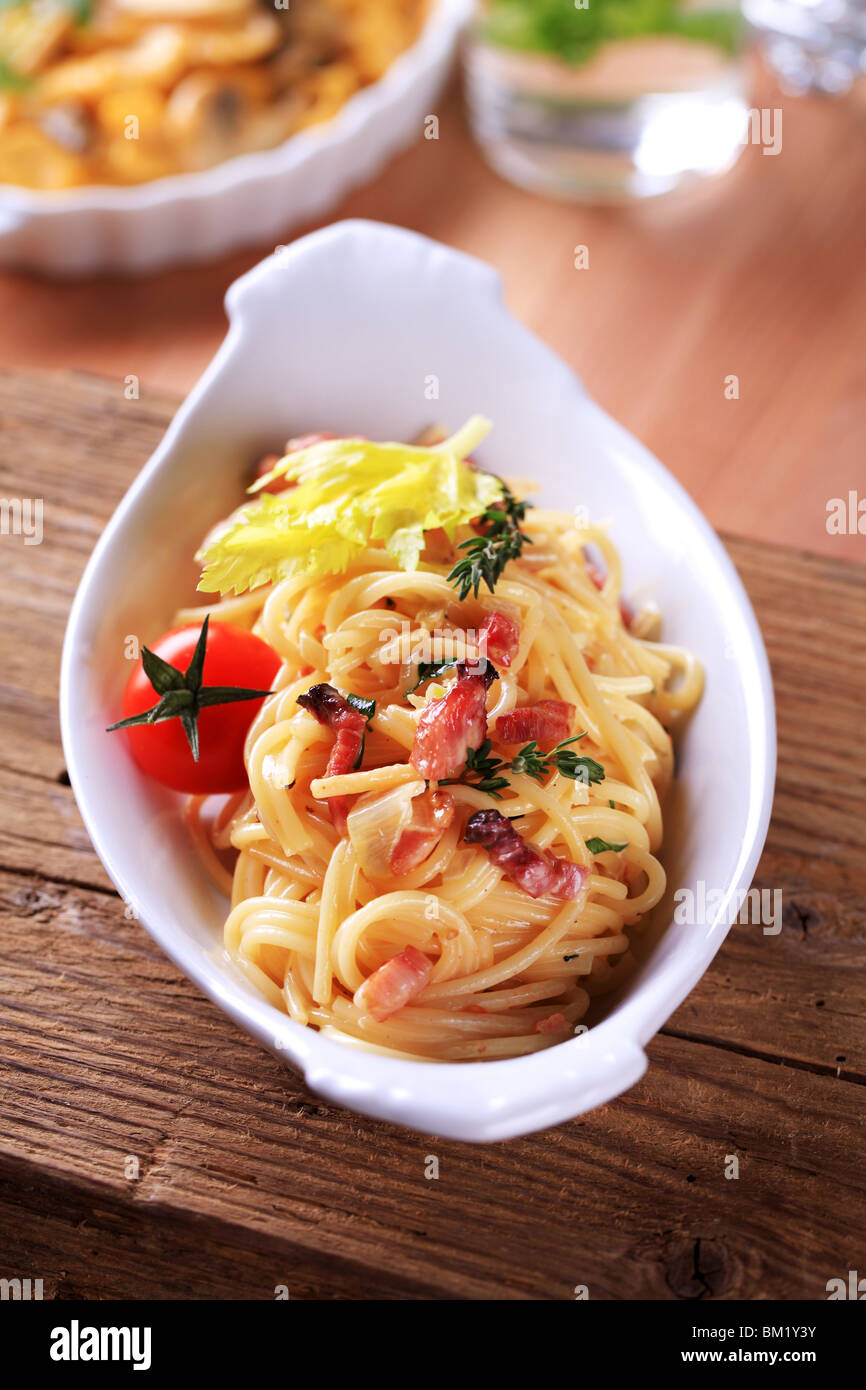 Bowl of spaghetti with bacon, onion and egg Stock Photo