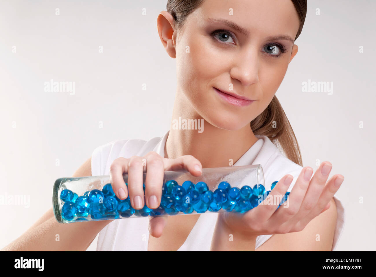 Woman pouring bath beads on her palm Stock Photo - Alamy