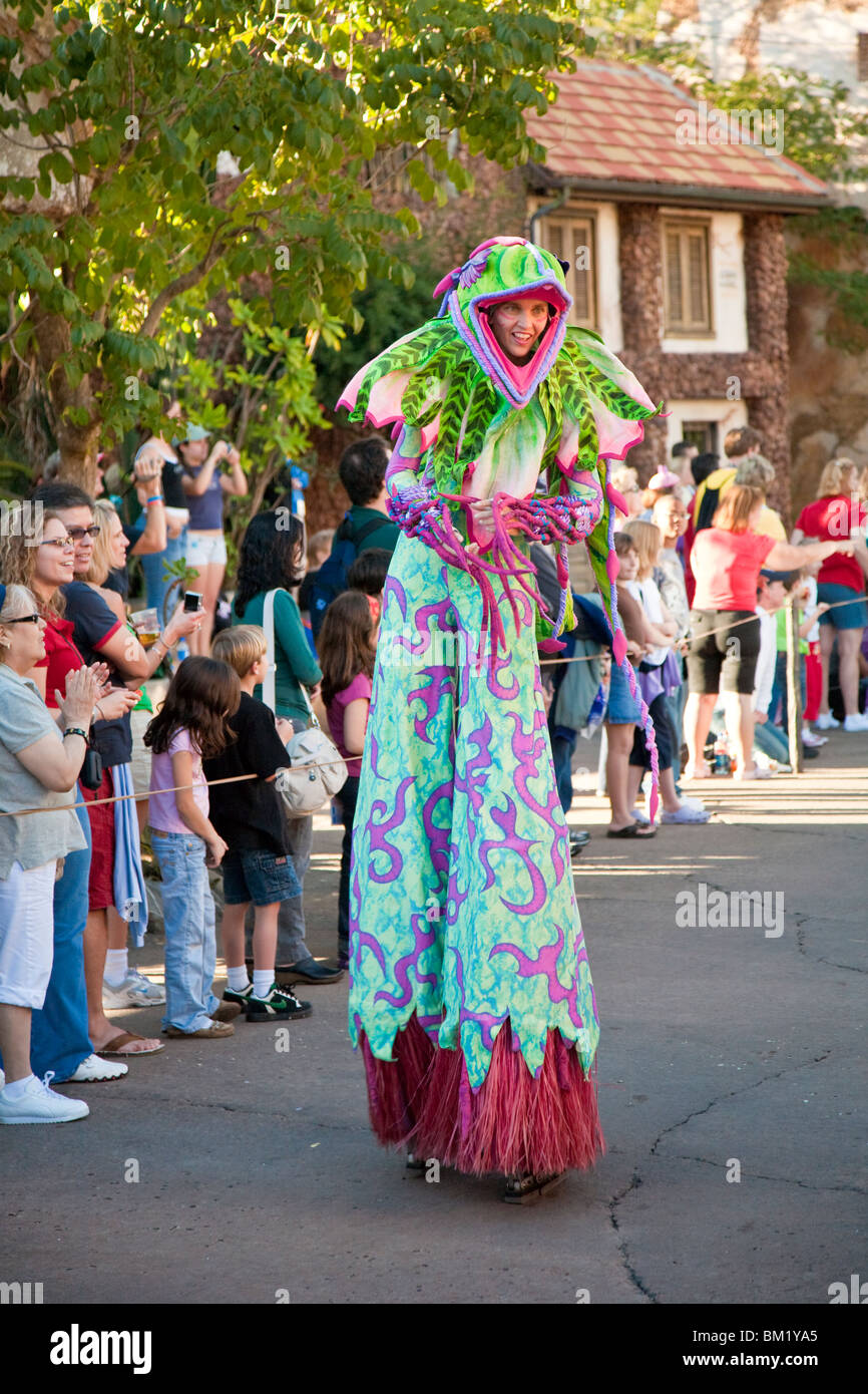 Female stilt walker entertains the guests in Jammin' Jungle Parade at Disney's Animal Kingdom in