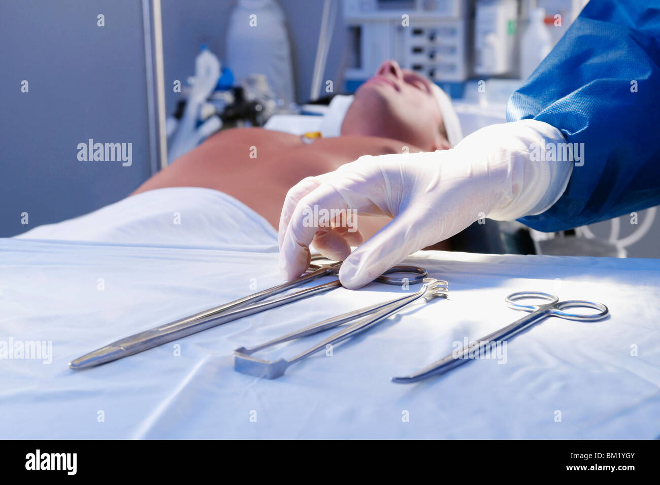 Surgeon holding surgical scissors in an operating room Stock Photo