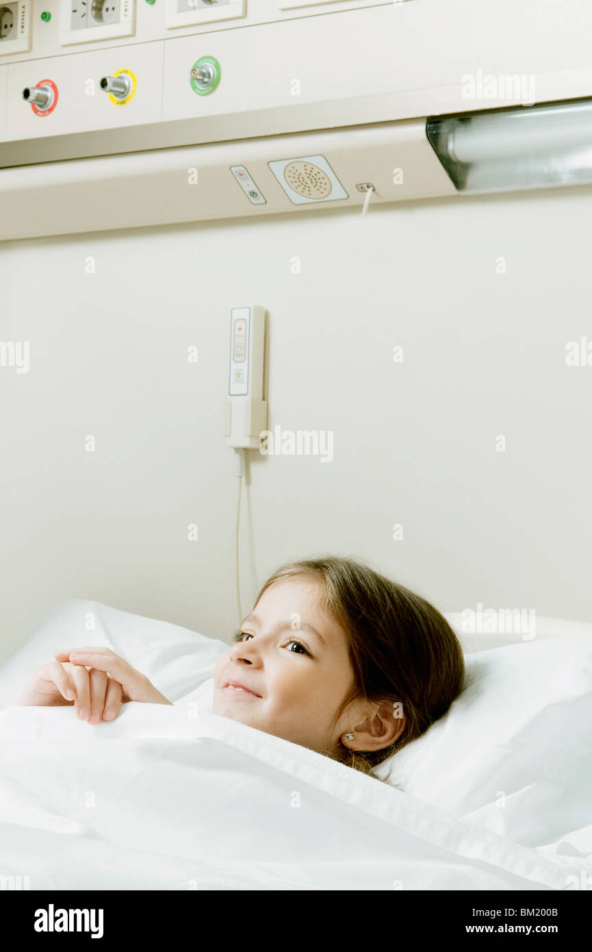 Girl smiling on a hospital bed Stock Photo - Alamy