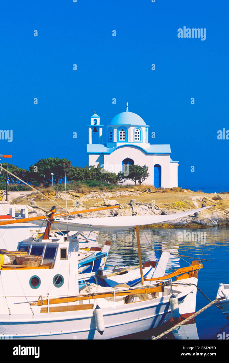 Fishing boats with a chapel in background, Chios Island, Greek Islands, Greece, Europe Stock Photo