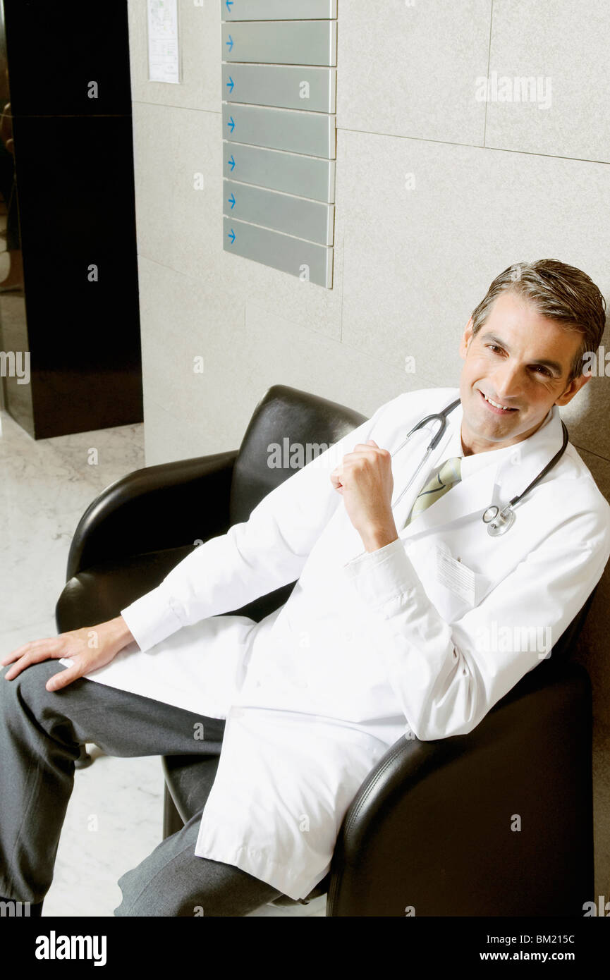 Male doctor smiling camera sitting hi-res stock photography and images ...