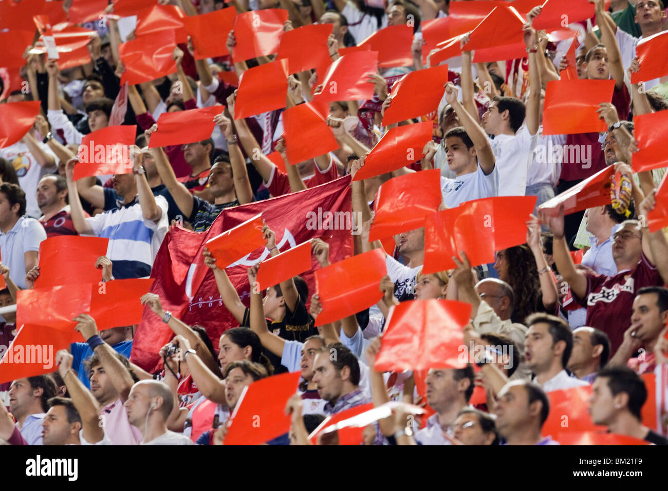 Sevilla FC fans doing a tifo with colored cards. Stock Photo