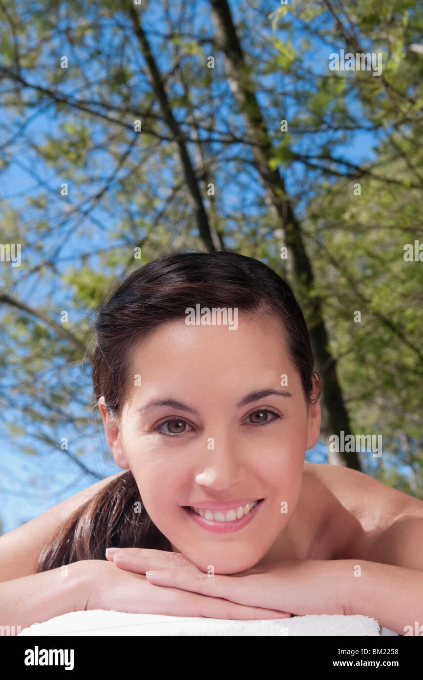 Portrait of a woman lying on a massage table and smiling Stock Photo
