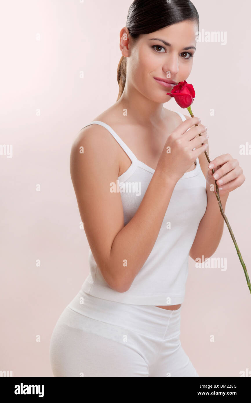 Portrait of a woman smelling a rose Stock Photo - Alamy
