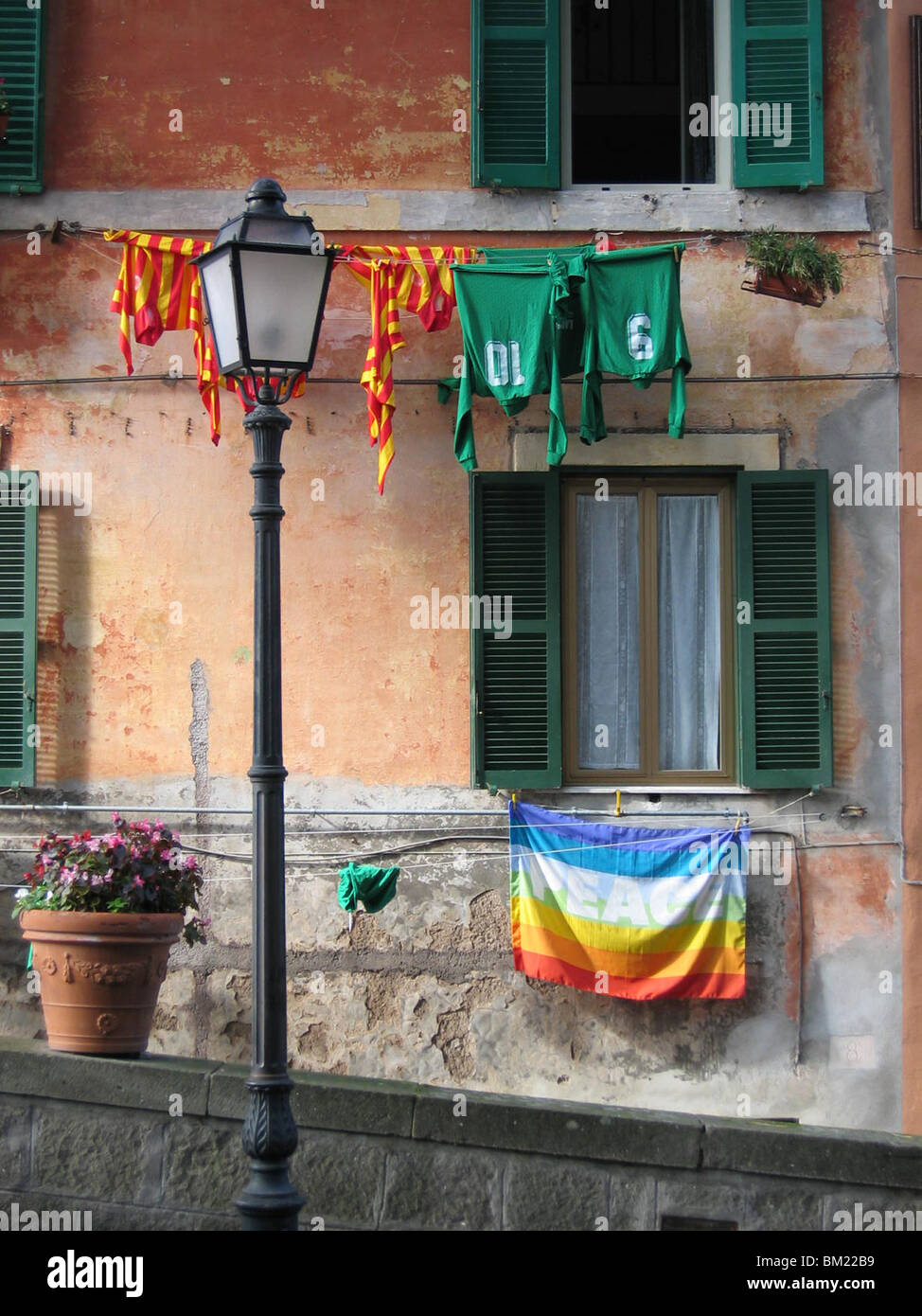 Peace flag hanging on the wall of a house in the small Italian city Castel Gandolfo, on top of an old volcano. Stock Photo