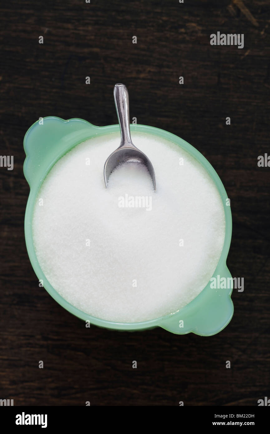 Green glass sugar bowl with mini scoop Stock Photo