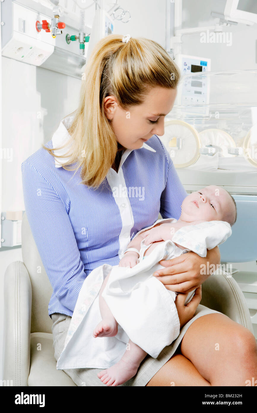 Woman carrying her newborn baby Stock Photo Alamy
