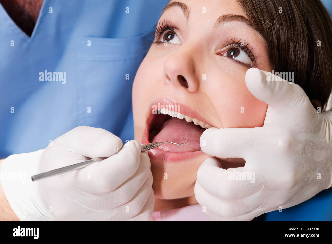 Dentist examining a woman's teeth Stock Photo
