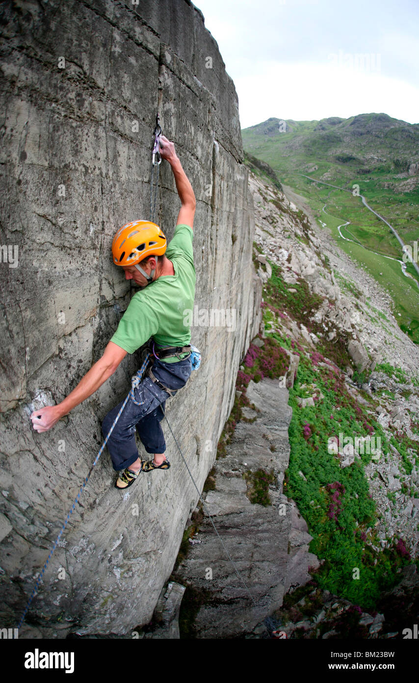 A rock climber makes a first ascent of on the cliffs above the