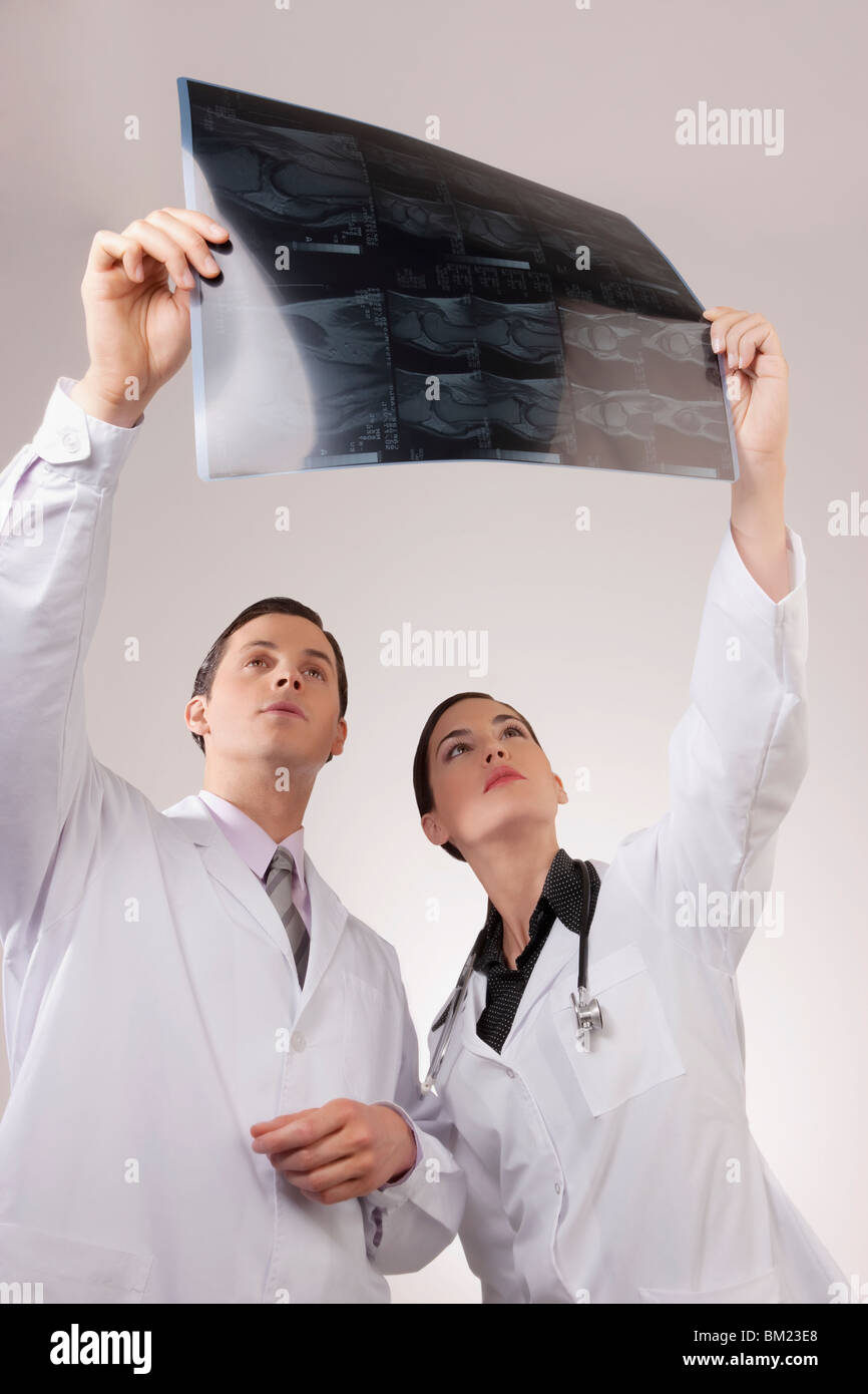 Doctors examining an x-ray report Stock Photo
