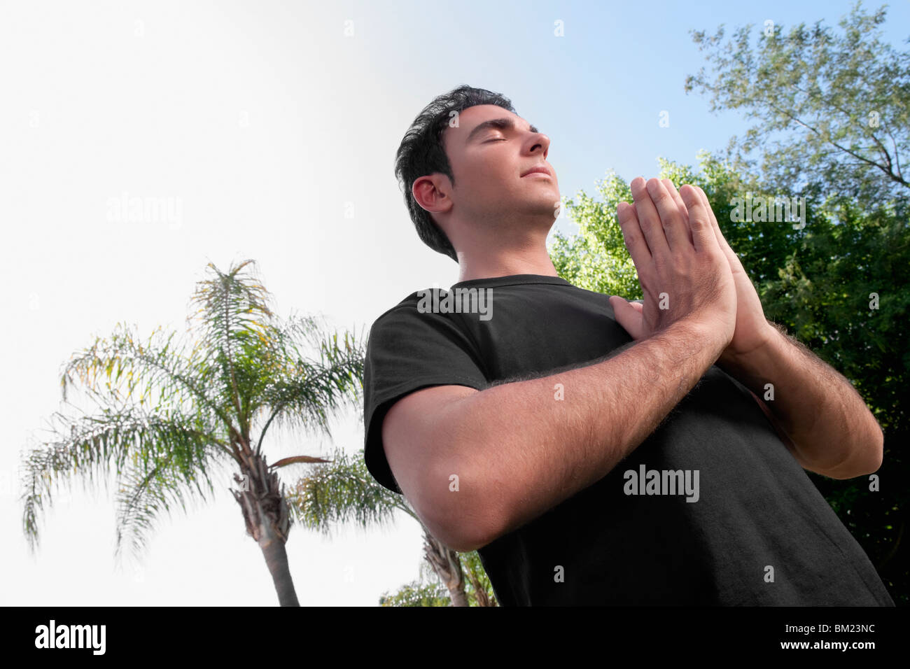 Man practicing yoga in a park Stock Photo - Alamy