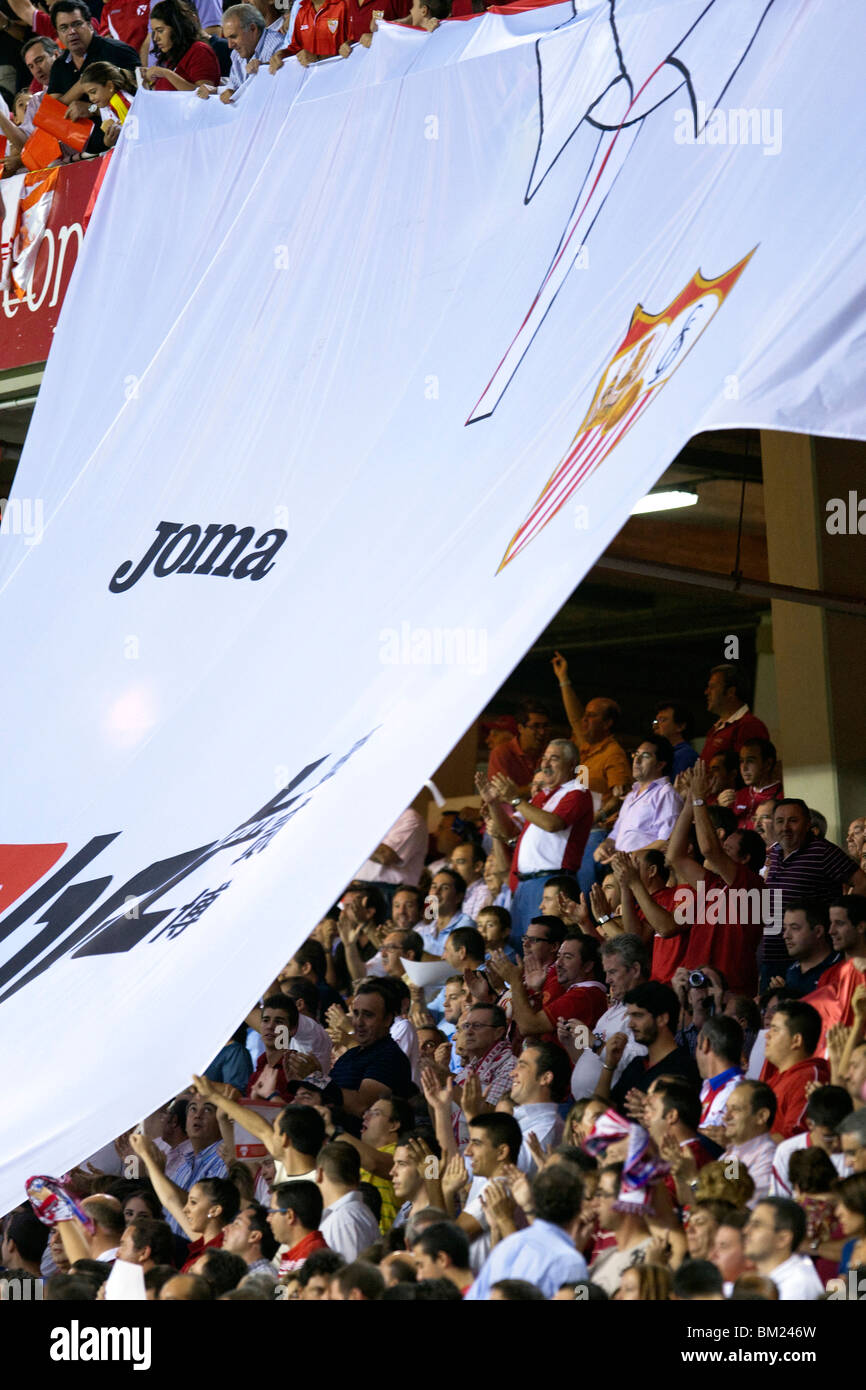 Sevilla FC fans doing a tifo with a gigantic shirt. Stock Photo