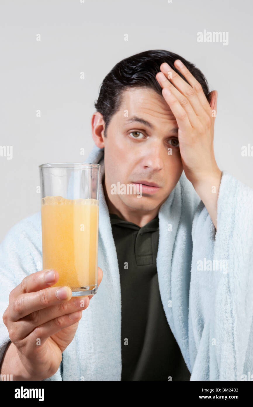 Portrait of a man taking orange juice Stock Photo Alamy