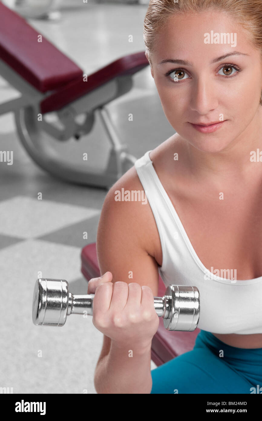Portrait of a woman exercising with a dumbbell Stock Photo
