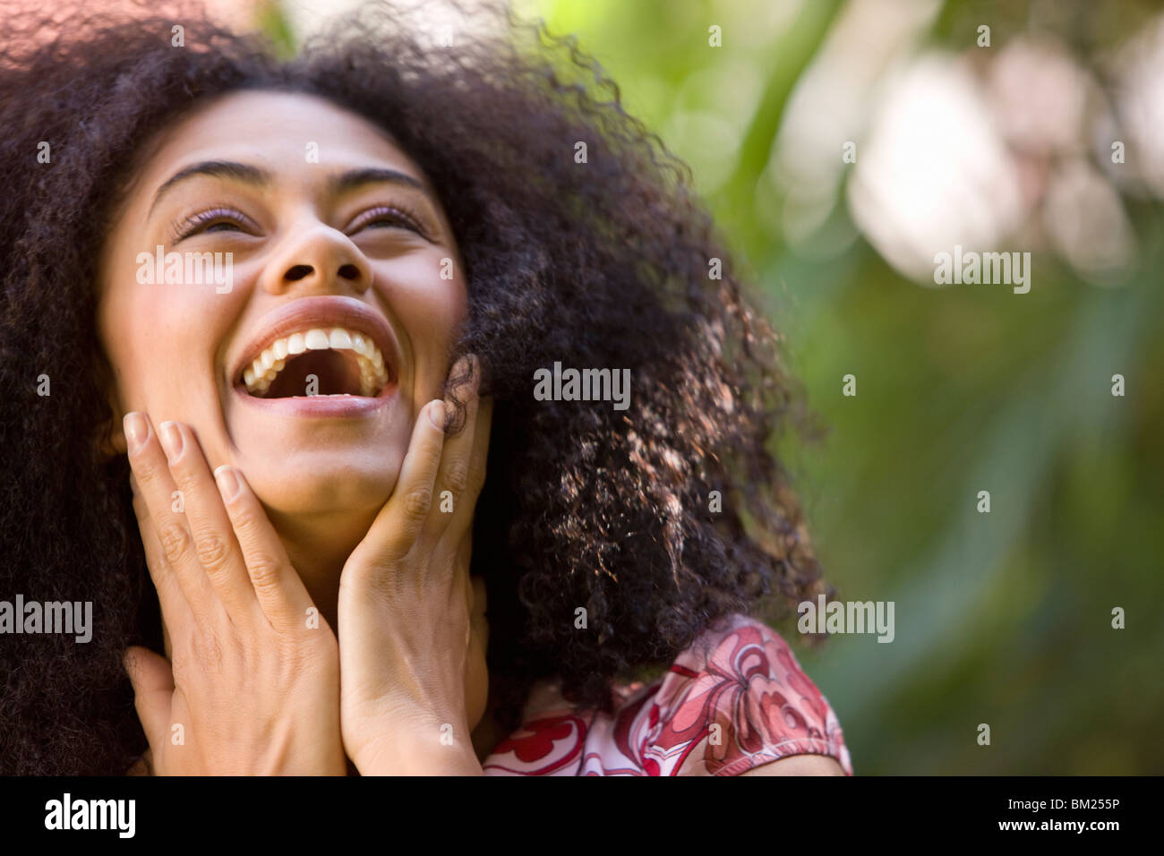 Woman touching cheek smiling hi-res stock photography and images - Alamy