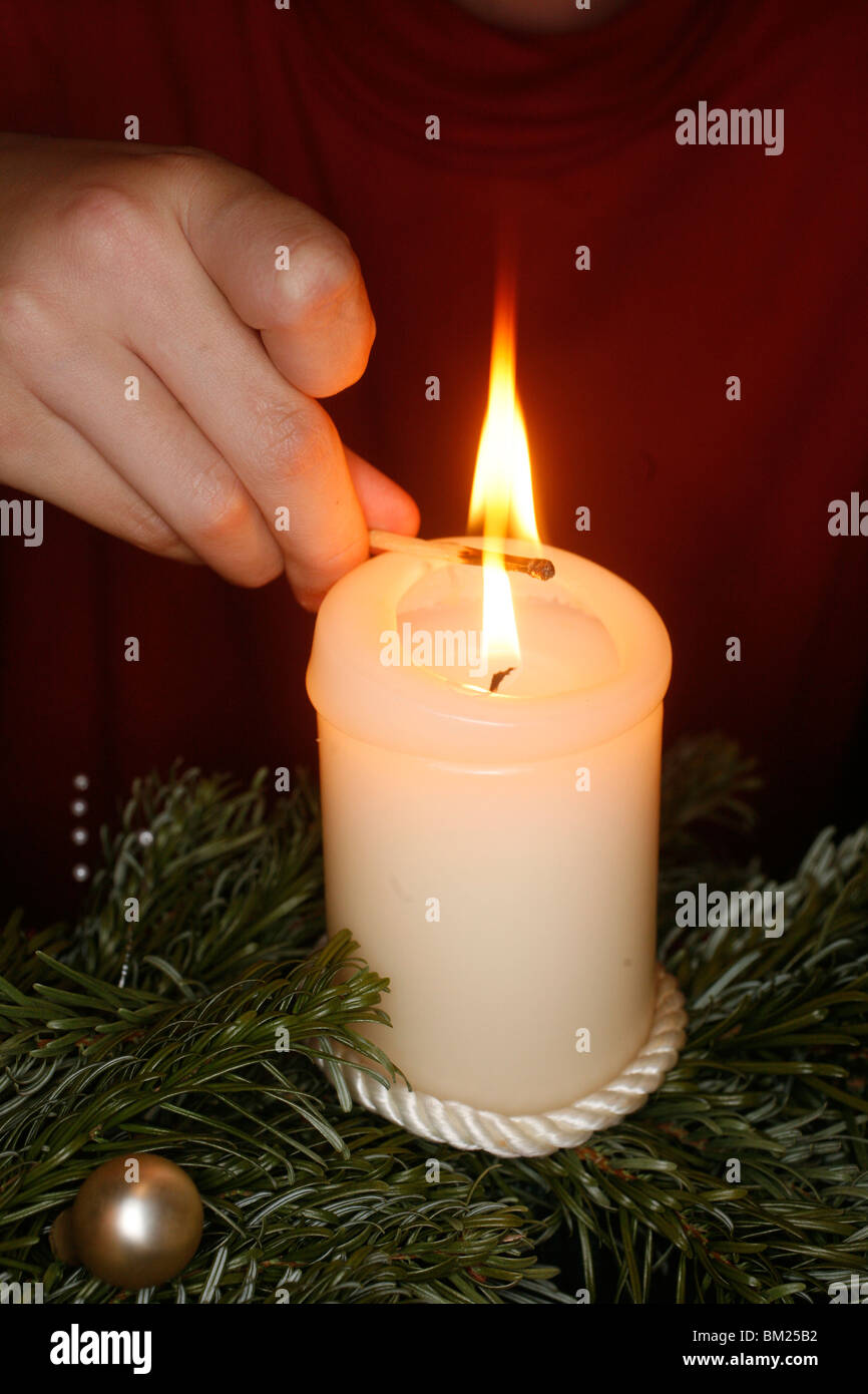 Lighting an Advent candle Stock Photo Alamy